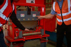 The manager is explaining the precautions and safety warning signs. attached to the machine for the engineering team in sheet steel factory Safety symbol concept in the work industry, engineering. The manager is explaining the precautions and safety warning signs. attached to the machine for the engineering team in sheet steel factory Safety symbol concept in the work industry, engineering.