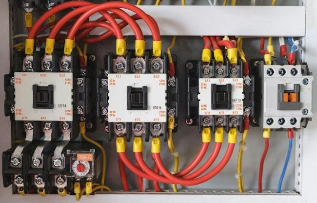 Close-up electrical wiring with fuses and contactors.