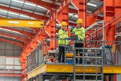 industrial apprenticeship. mentor teaching new employees trainee operating machine looking monitors and check machinery. Two industrial engineer technician In factory explain operating machine. industrial apprenticeship. mentor teaching new employees trainee operating machine looking monitors and check machinery. Two industrial engineer technician In factory explain operating machine.