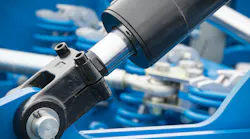Black piston or actuator as part of blue pneumatic or hydraulic machine. Technology and engineering