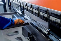 The technician operator uses hydraulic bending machine. The technician operator uses hydraulic bending machine.