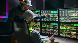 Head engineer and factory operator following product process on factory uses SCADA system and industry 4.0. Two operators control assembly line using screens with human-machine interface