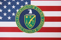 U.S. Department of Energy seal on United States of America flag close up U.S. Department of Energy seal on United States of America flag close up
