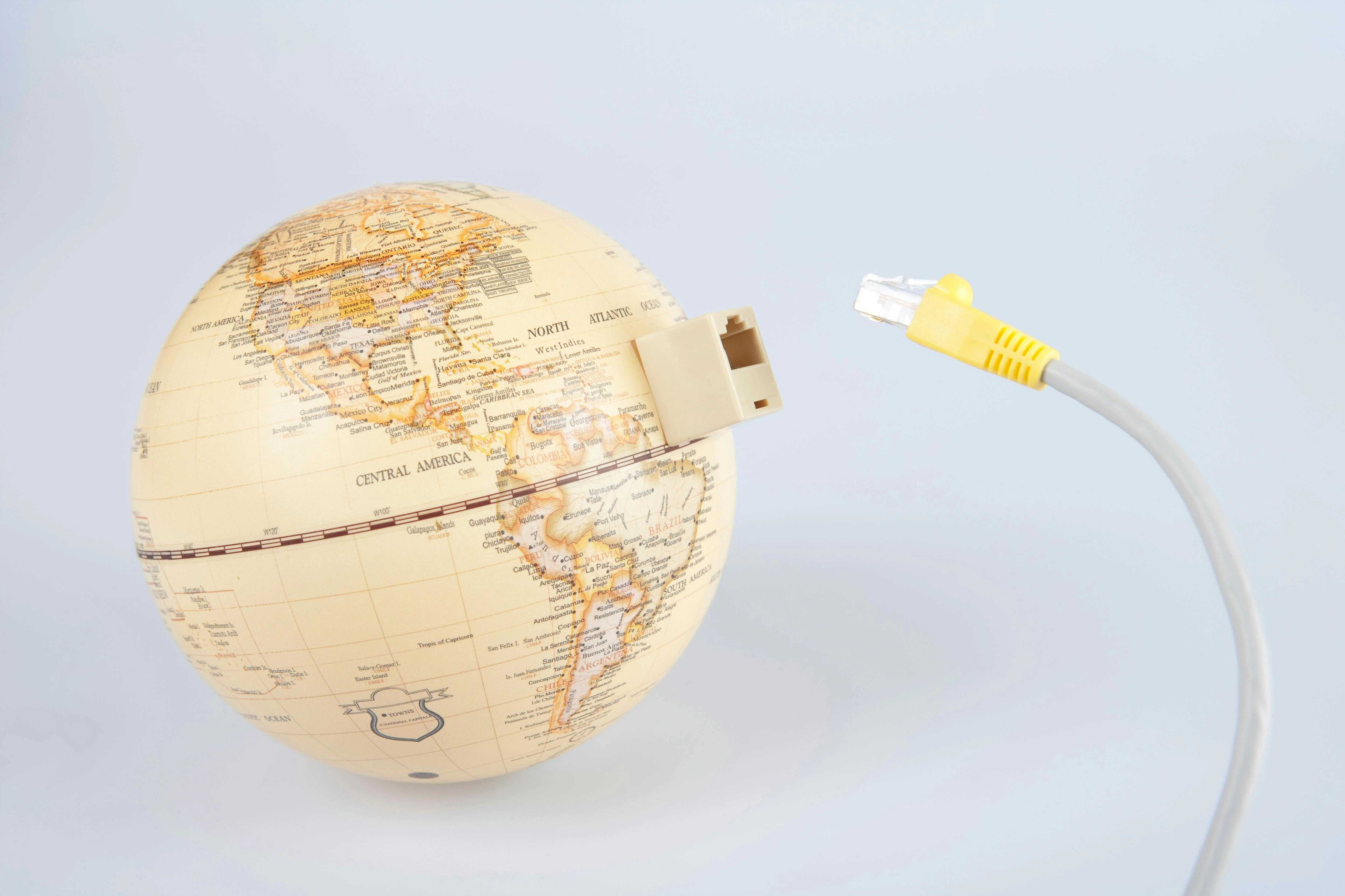 Globe with ethernet cable showing connection to the world