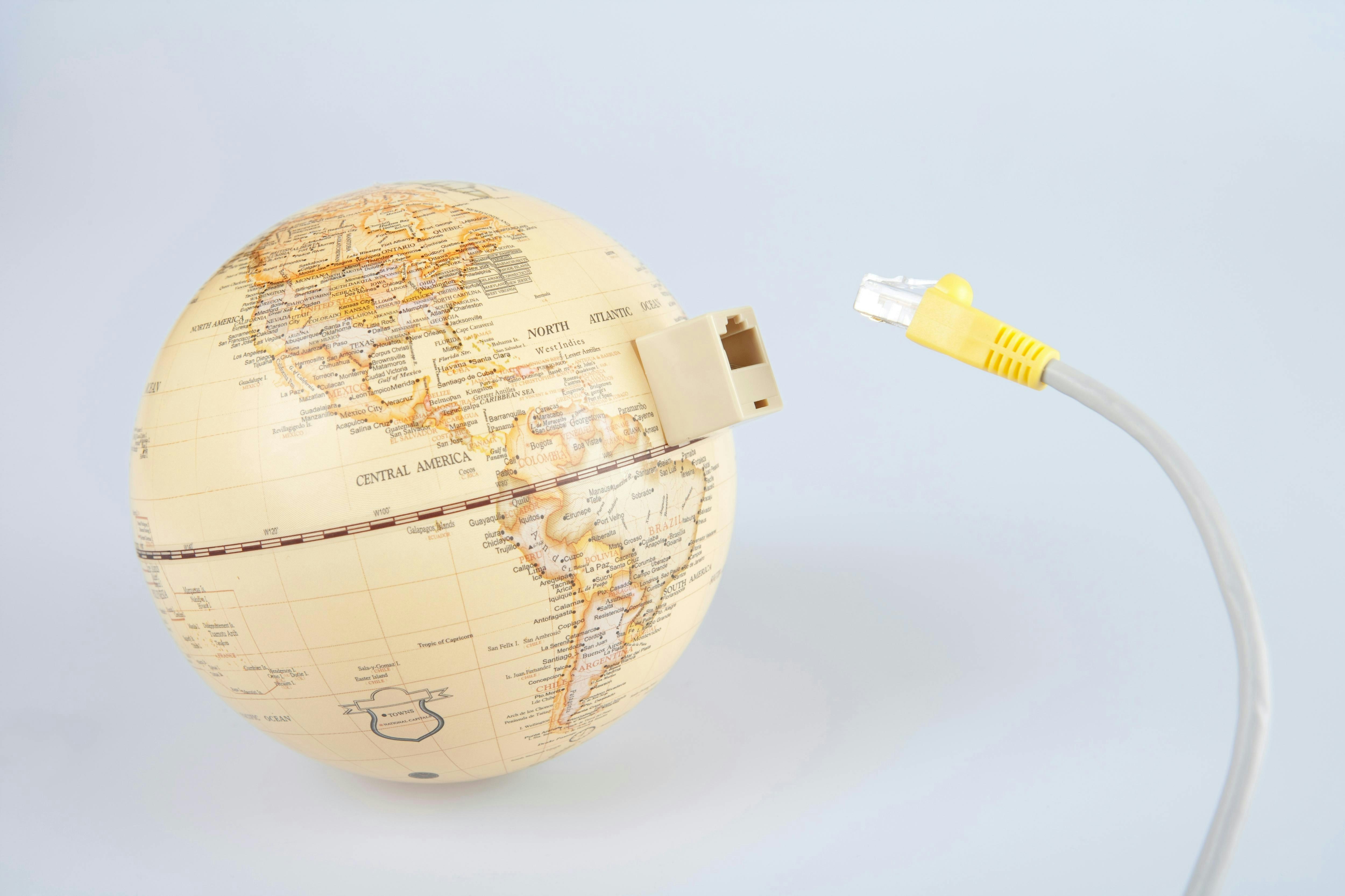Globe with ethernet cable showing connection to the world