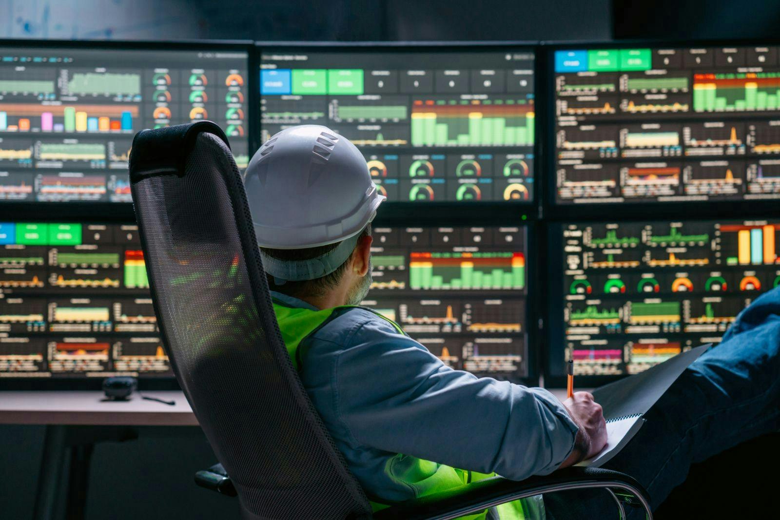 Head engineer following the factory process using Industry 4.0. Facility operator control production uses computer screens with SCADA system