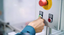 close-up, on a special shield, the hand presses the green start button, next to the red-stop close-up, on a special shield, the hand presses the green start button, next to the red-stop