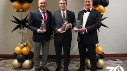 Cybertrol executives celebrate the company's 30th anniversary with commemorative plaques.