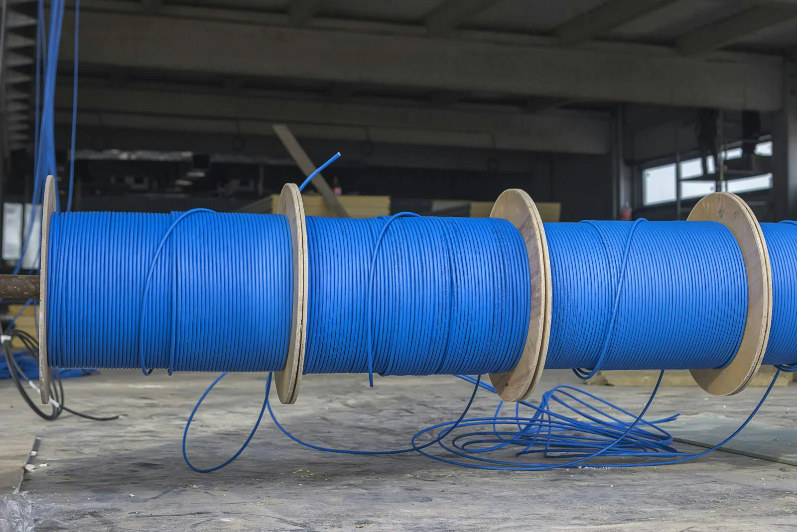 Blue ftp ethernet cable reels on a building site.