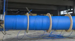 Blue ftp ethernet cable reels on a building site.