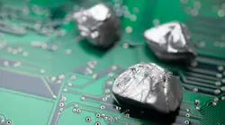 Mineral rare earth element on green electronic circuit board background.
