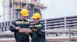 Engineers working with tablet in industry oil refinery oil, gas refinery background.