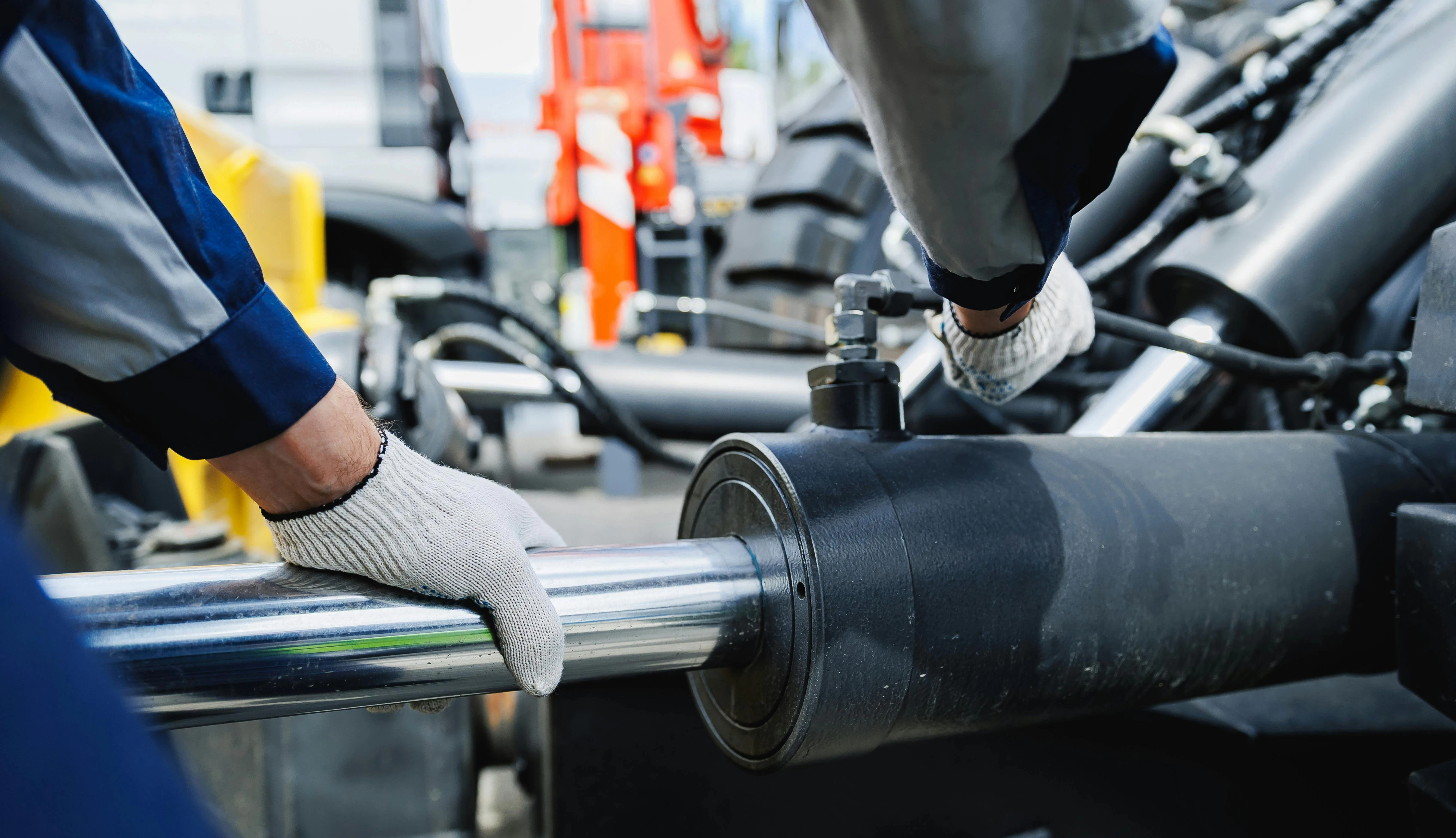 Worker mechanic check pipe system of hydraulic hose valves in industry machinery.