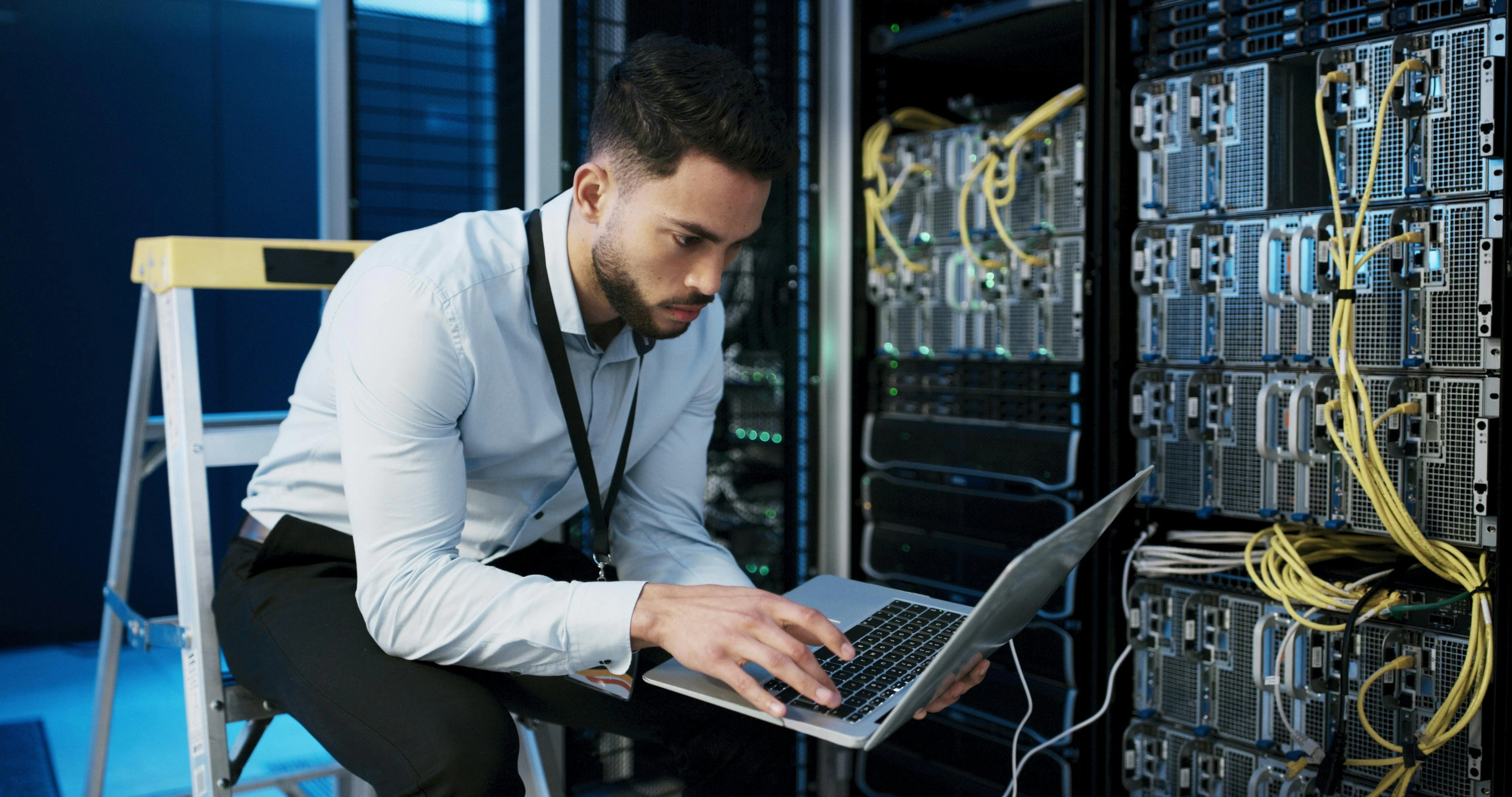 Man with laptop, typing and check server