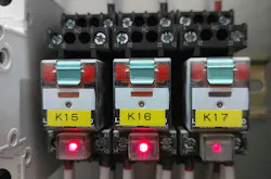An electrical relay bank inside an industrial control panel. An electrical relay bank inside an industrial control panel.