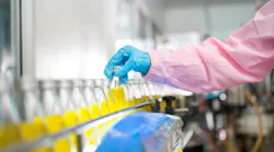 Female quality control inspector checking bottled fruit juice on production line in beverage factory, using tablet for monitoring and inspection Female quality control inspector checking bottled fruit juice on production line in beverage factory, using tablet for monitoring and inspection