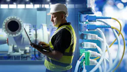 Industrial networking, equipment maintenance. Engineer uses laptop near network cables and machinery, monitoring systems and ensuring connectivity in production facility. Industrial networking, equipment maintenance. Engineer uses laptop near network cables and machinery, monitoring systems and ensuring connectivity in production facility.