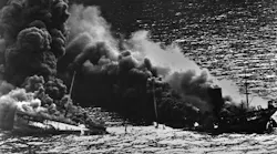 Allied tanker torpedoed in Atlantic Ocean by German submarine during World War 2. The ship crumbled amidships under heat of fire as she settled toward bottom of sea. 1942.