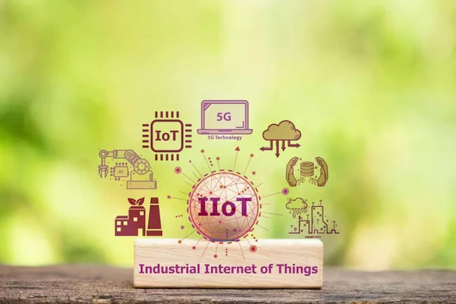 IIoT or Industrial Internet of Things text on woods and icons on natural background.