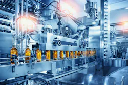 Conveyor belt with juice bottles on beverage factory interior in blue color. Conveyor belt with juice bottles on beverage factory interior in blue color.