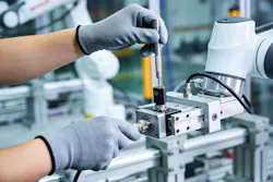 A worker in protective gloves carefully adjusts a sensor on an automated assembly line, highlighting advanced manufacturing processes and quality control A worker in protective gloves carefully adjusts a sensor on an automated assembly line, highlighting advanced manufacturing processes and quality control