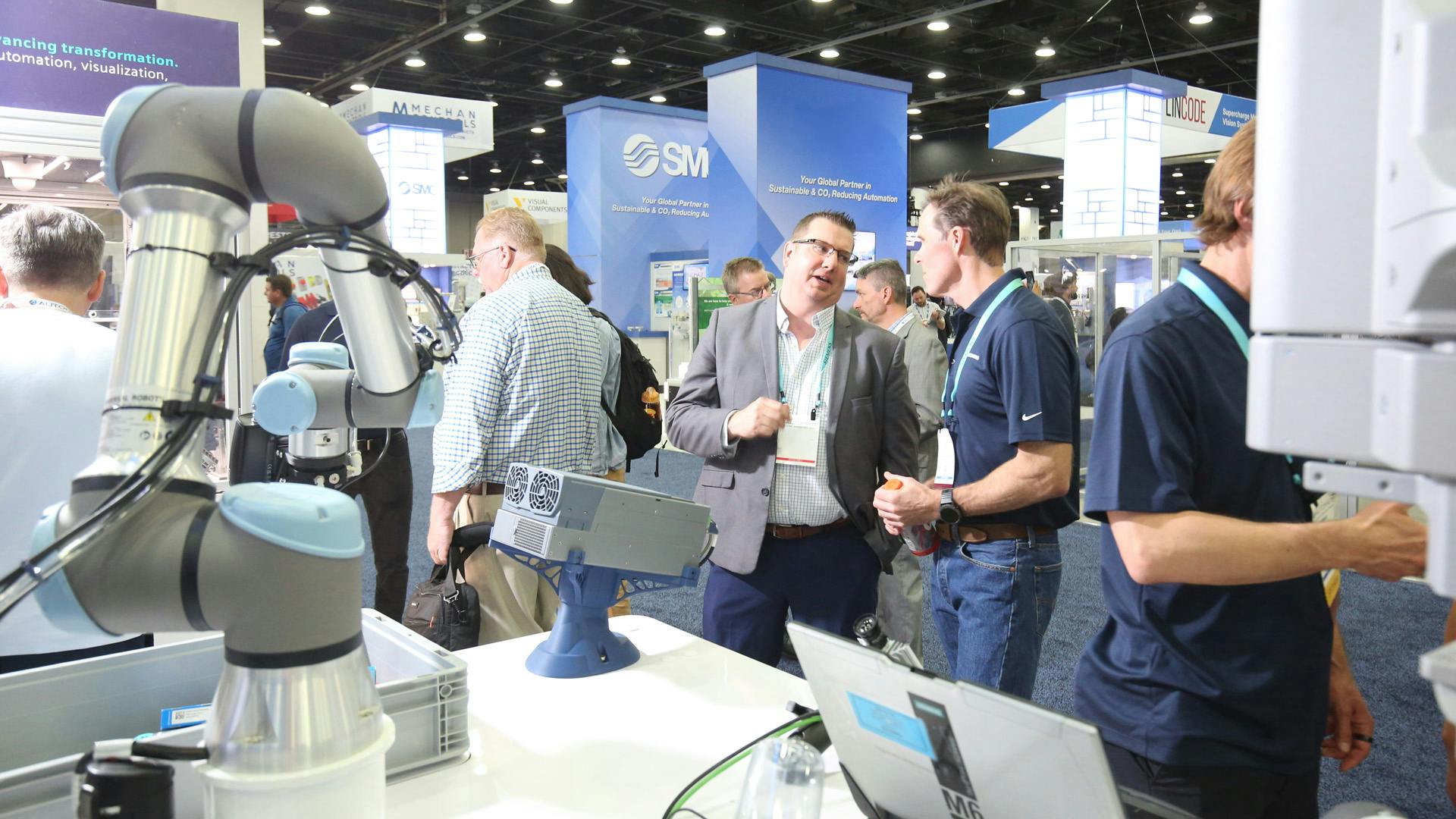 Attendees on the display floor at Automate 2026 in Chicago looking at robots and other industrial technologies.