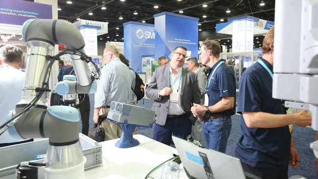 Attendees on the display floor at Automate 2026 in Chicago looking at robots and other industrial technologies.