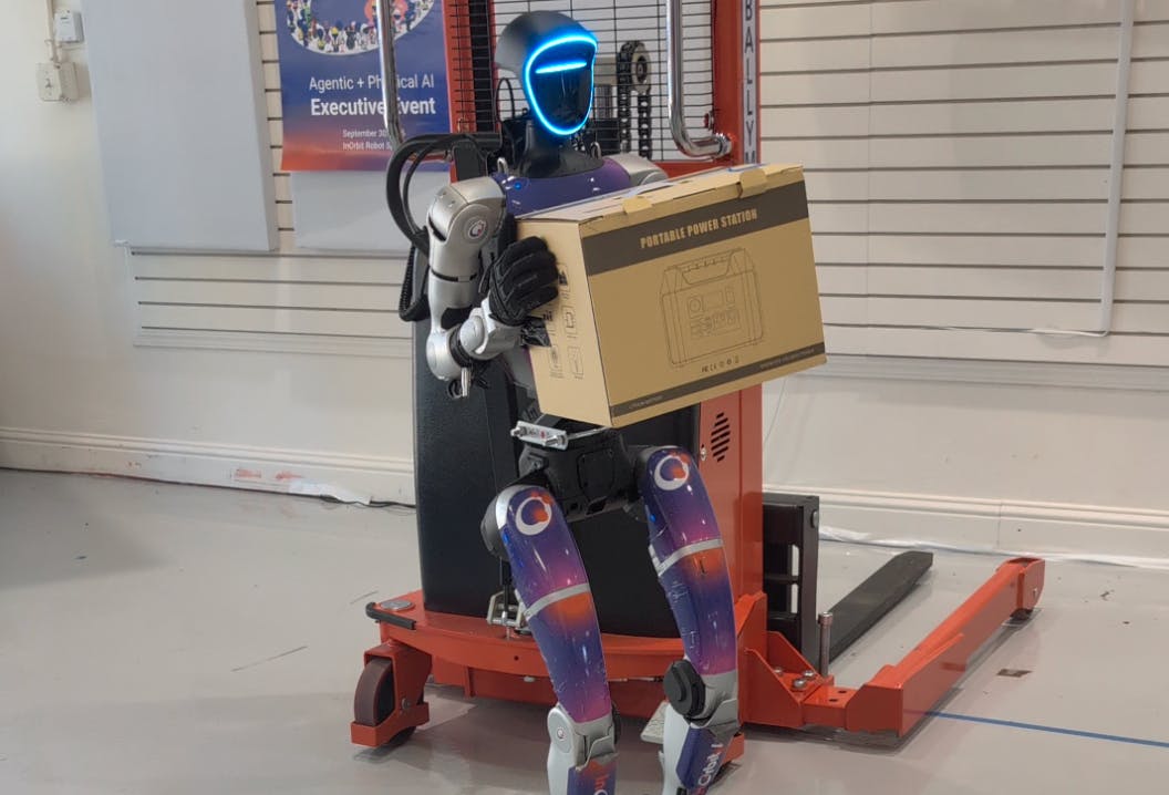 InOrbit.AI robot carrying a package in a factory facility