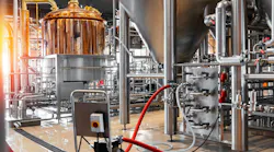 Pipes, stainless steel brewing equipment and large reservoirs or tanks in a modern beer factory.