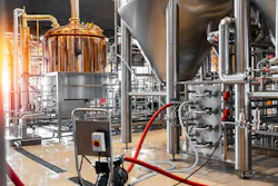 Pipes, stainless steel brewing equipment and large reservoirs or tanks in a modern beer factory.