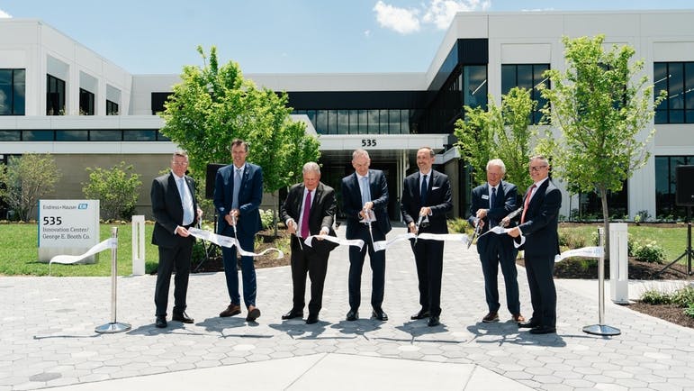 Endress+Hauser employees cutting the opening ribbon outside the new Greenwood facility.