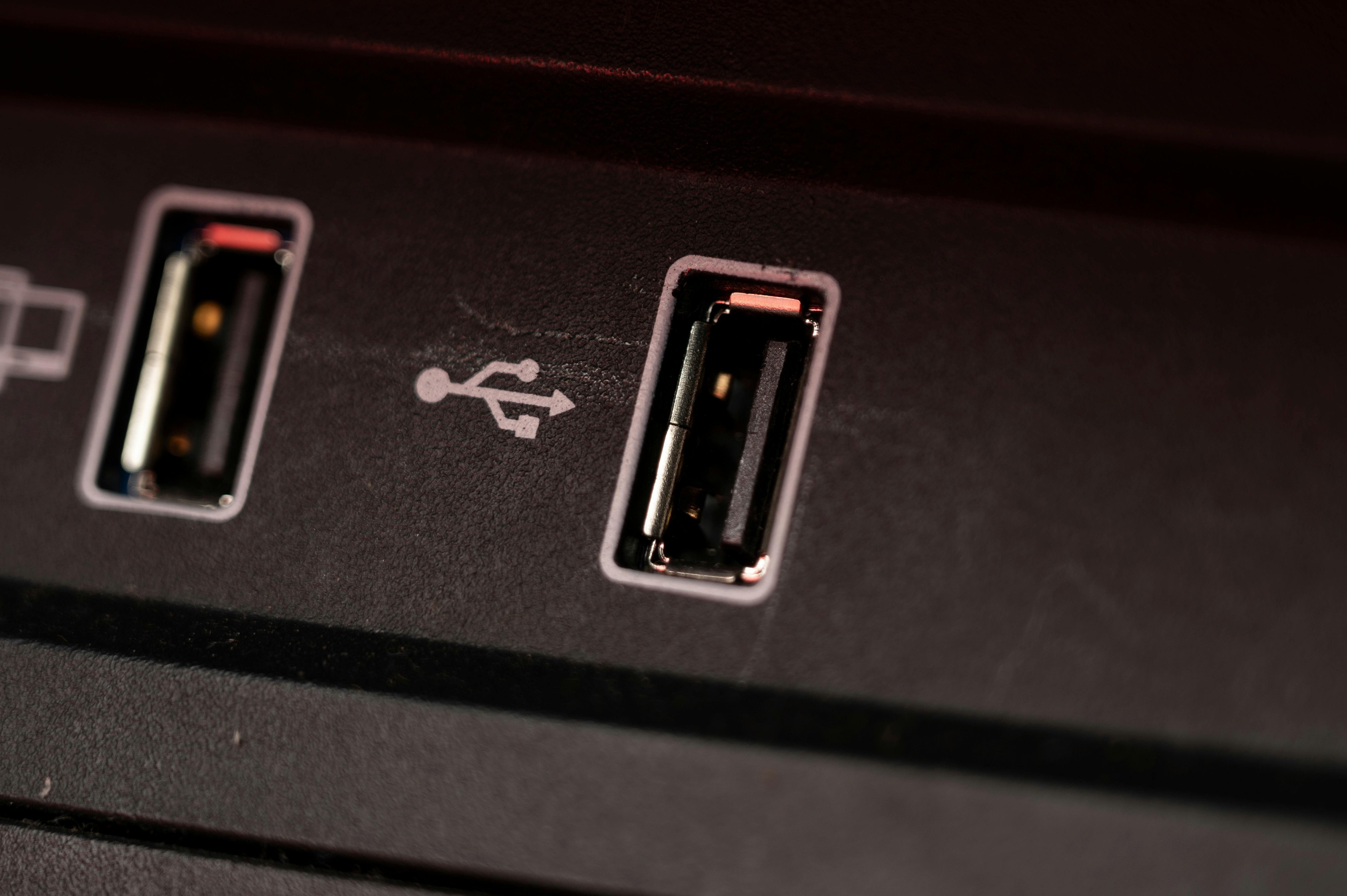 Opened car USB port in the car for connecting device. Power output of usb charger close up view.