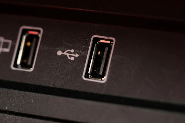 Opened car USB port in the car for connecting device. Power output of usb charger close up view.