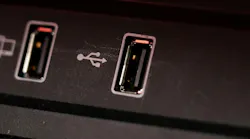 Opened car USB port in the car for connecting device. Power output of usb charger close up view.