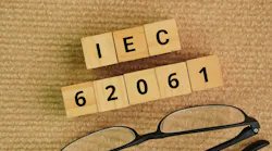 Glasses and wooden cubes with the words IEC 62061. Safety of machinery – Functional safety of safety-related electrical, electronic and programmable electronic control systems