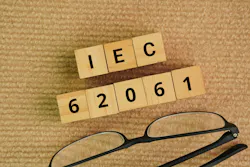 Glasses and wooden cubes with the words IEC 62061. Safety of machinery – Functional safety of safety-related electrical, electronic and programmable electronic control systems