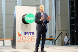Doug Woods speaking in front of a podium at IMTS 2026