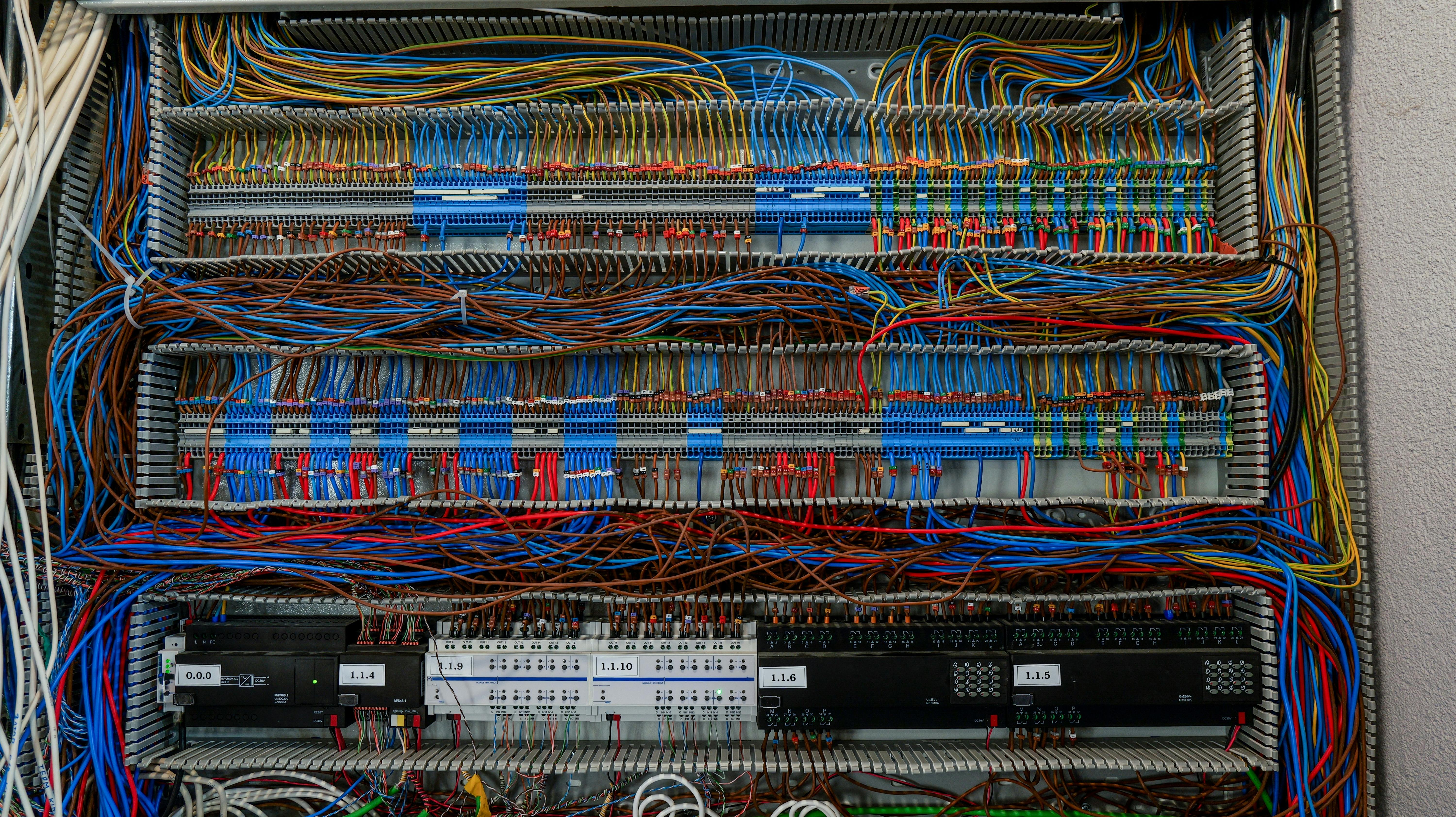 Shot of an intricate network of wires and connections within an electrical control panel