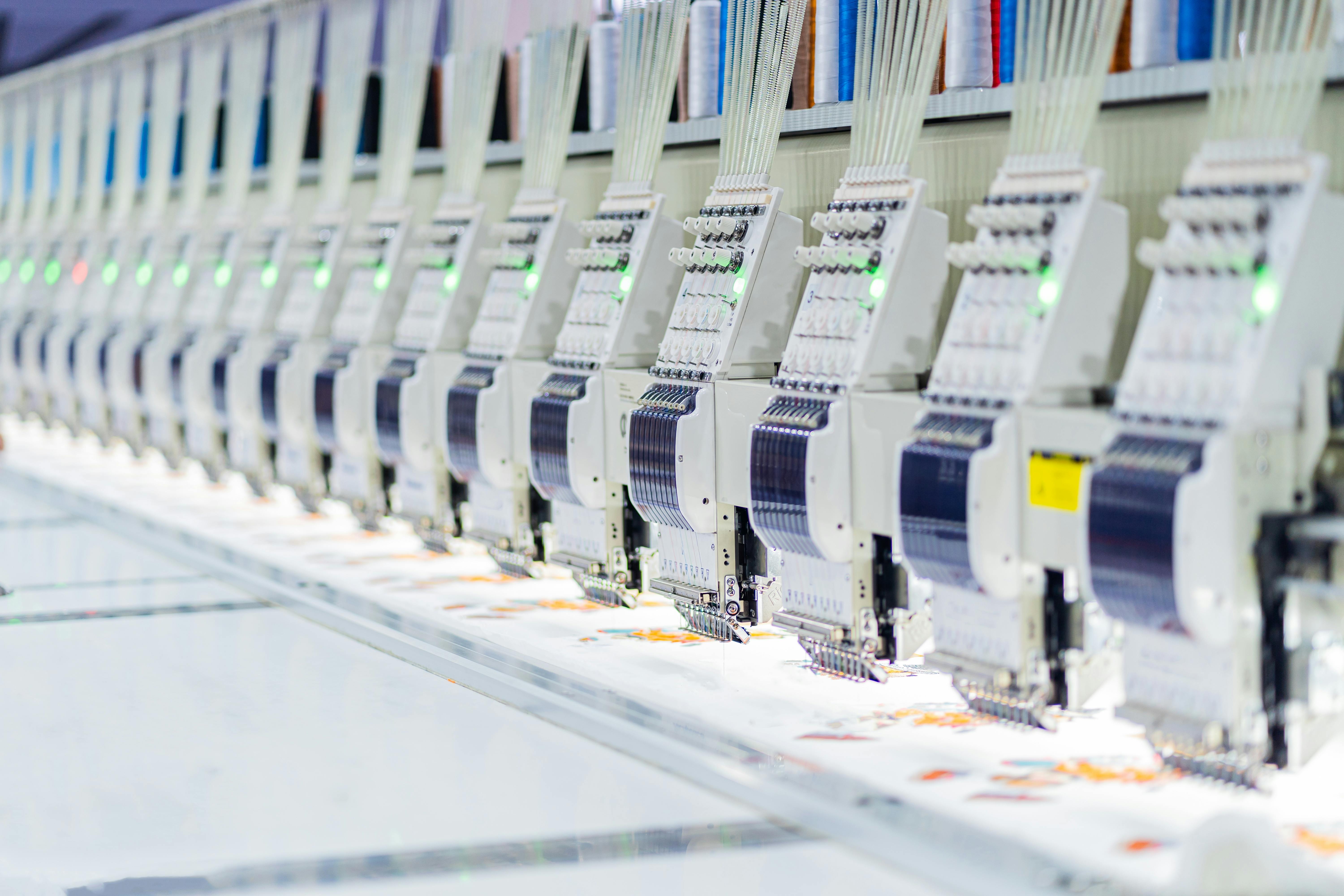 Industrial embroidery and sewing machines Automatic Embroidery Machine In A Clothing Factory Automatic Embroidery Machine in Textile Factory High technology sewing machine control by computer programing